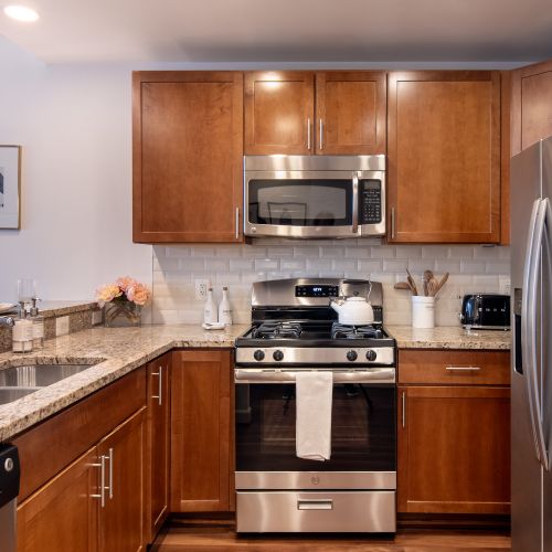 Gourmet kitchens with stainless steel appliances, granite countertops, and cherry wood cabinets.