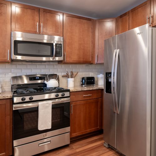 Gourmet kitchens with stainless steel appliances, granite countertops, and cherry wood cabinets.