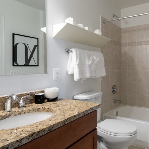 Bathrooms with stand-up showers and cherry wood double vanities. 