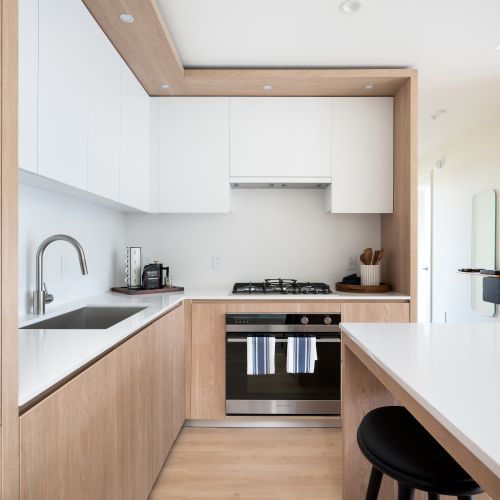 Gas range cooktop with integrated full capacity hood fan.