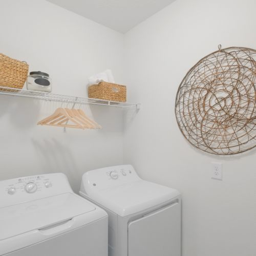 Find a full-sized washer and dryer tucked away in your cozy laundry room.	
