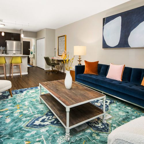 Spacious living area with comfortable seating, a media console, and a bar cart.