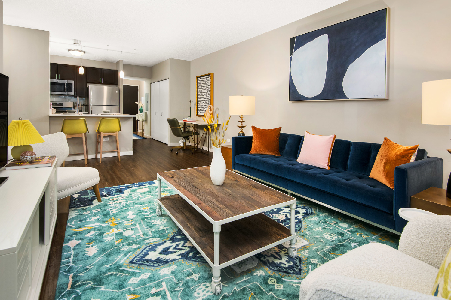 Spacious living area with comfortable seating, a media console, and a bar cart.