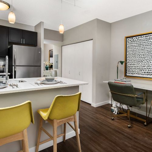Close-up of a spacious kitchen with ample cabinetry storage, stainless steel appliances, a large island.