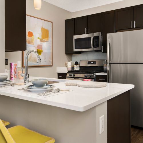 Kitchen close-up of a quartz countertop with formal table setting for two.
