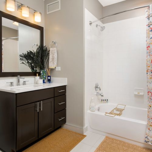 Spa-inspired bathroom with warm wood cabinetry and a walk-in shower.