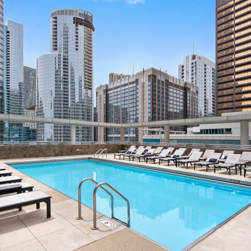 Close up of Atwater's pool on the outdoor sundeck with comfortable lounge seating arranged on the sides.