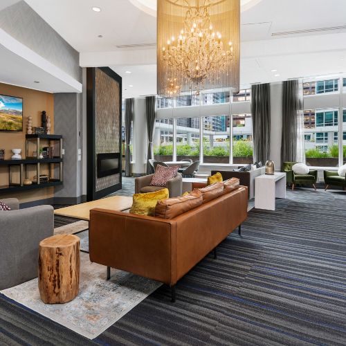Wide angle of the resident lounge decorated with comfortable couches and table sets.