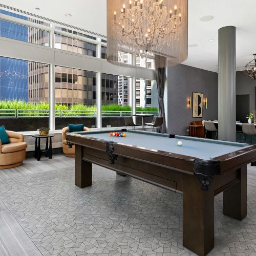 Wide angle of the resident lounge's billiard table and seating.