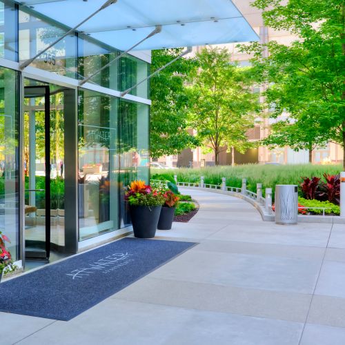 Side angle of Atwater's entrance with lush foliage in the background.