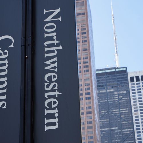 Eye-level street view of Northwestern University students walking past Starbucks.