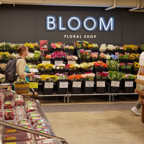 Interior image of Whole Foods produce, flowers, and wine.