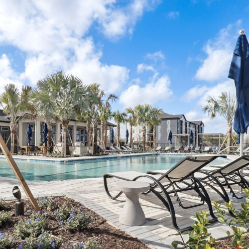 Avida's resort-style pool features an abundance of comfortable seating. 	