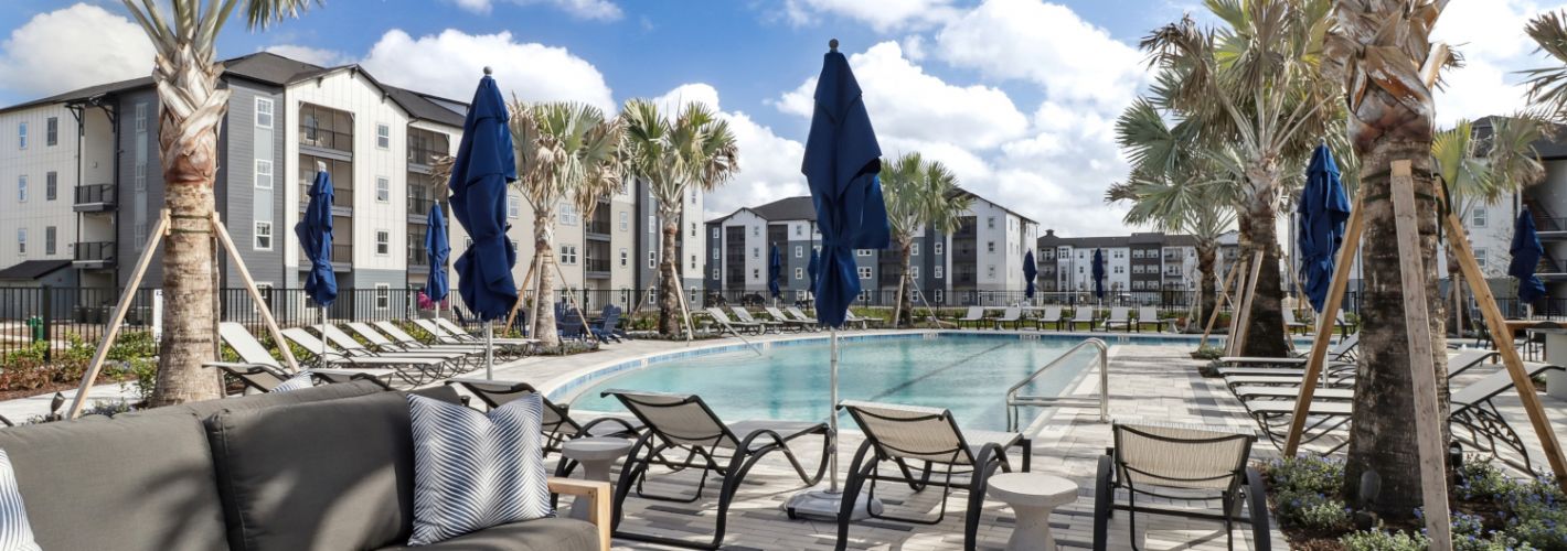 Avida : Avida's resort-style pool features an abundance of comfortable seating. 	