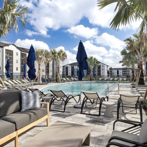 Avida's resort-style pool features an abundance of comfortable seating. 	