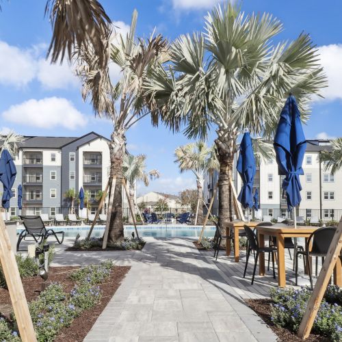 Avida's resort-style pool features an abundance of comfortable seating. 	