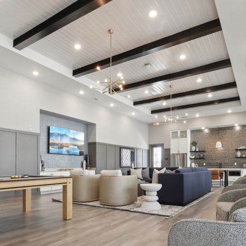 Entertain in the expansive clubroom, complete with a large flat screen TV, pool table, kitchen, and outdoor covered lanai with stunning views. 	