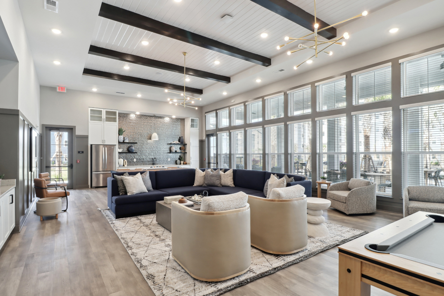 Avida : Entertain in the expansive clubroom, complete with a large flat screen TV, pool table, kitchen, and outdoor covered lanai with stunning views. 	