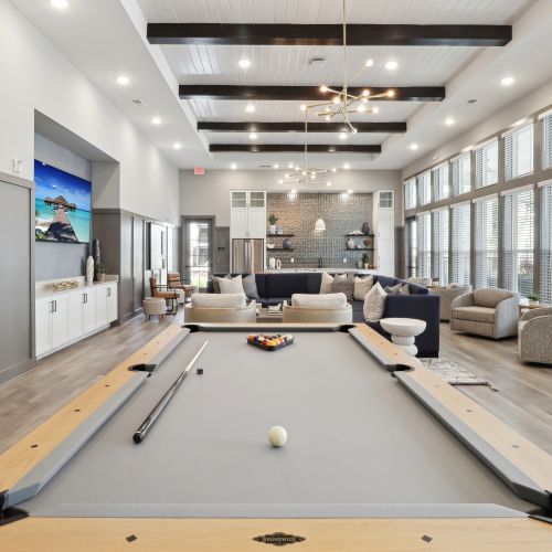 Entertain in the expansive clubroom, complete with a large flat screen TV, pool table, kitchen, and outdoor covered lanai with stunning views. 	