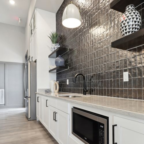 Entertain in the expansive clubroom, complete with a large flat screen TV, pool table, kitchen, and outdoor covered lanai with stunning views. 	