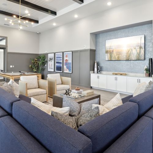 Entertain in the expansive clubroom, complete with a large flat screen TV, pool table, kitchen, and outdoor covered lanai with stunning views. 	