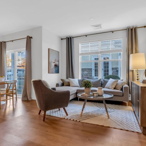 Living room with views of large windows and balcony	