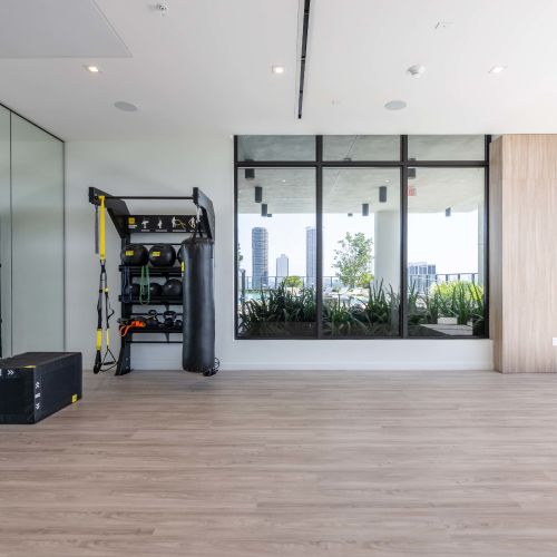 Light filled yoga room with pool and skyline views