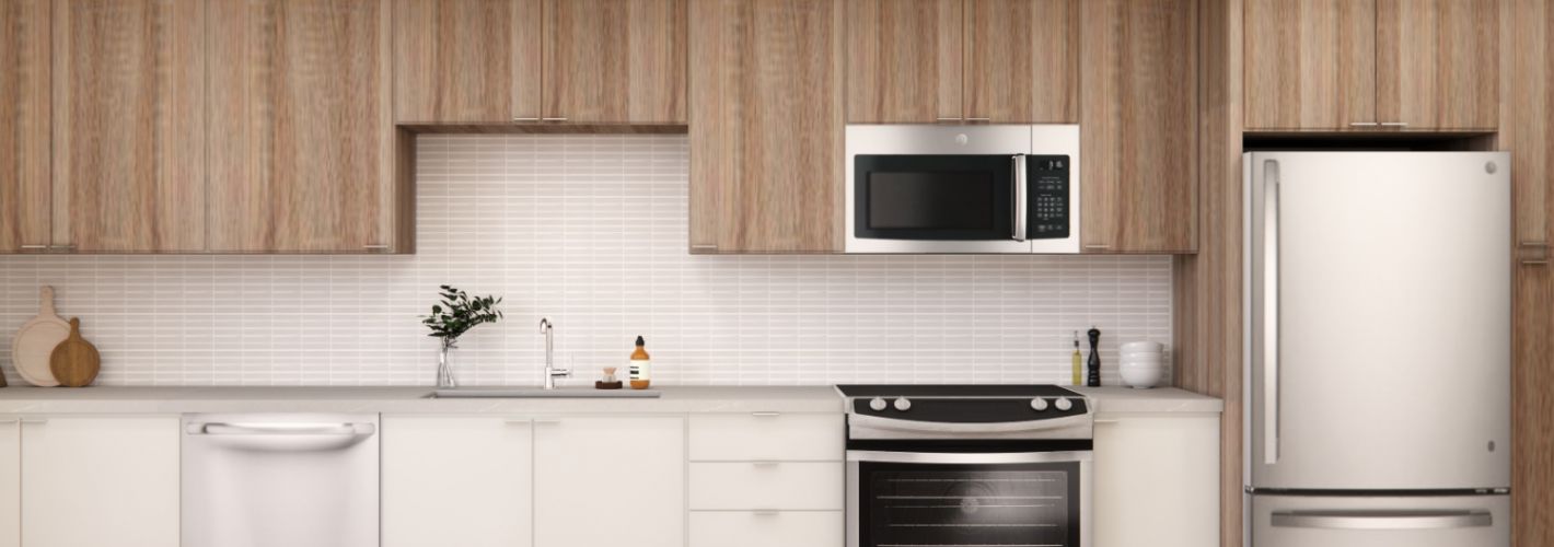 Aura Arts District : Embrace spacious kitchens with warm wooden cabinets and stainless steel appliances.	