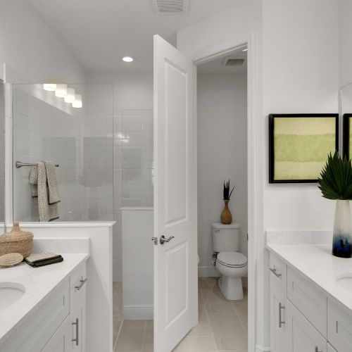 Plush primary bathrooms with dual sinks	