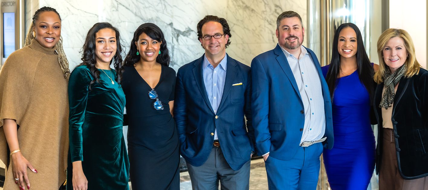 A group of team members pose for a photo representing Bozzuto as a top workplace by USA Today
