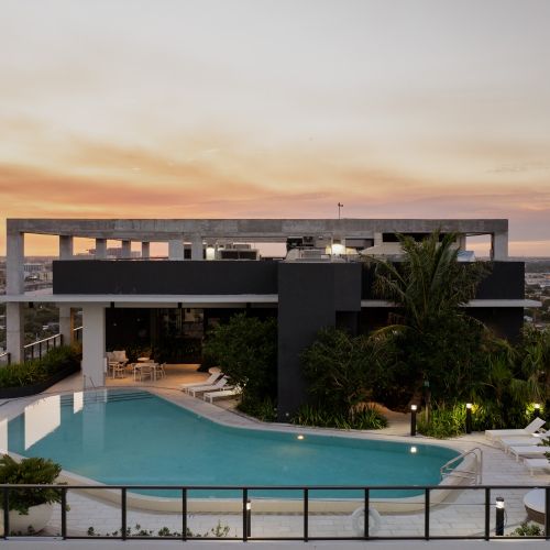 Rooftop pool with the glow of the Miami skyline at sunset