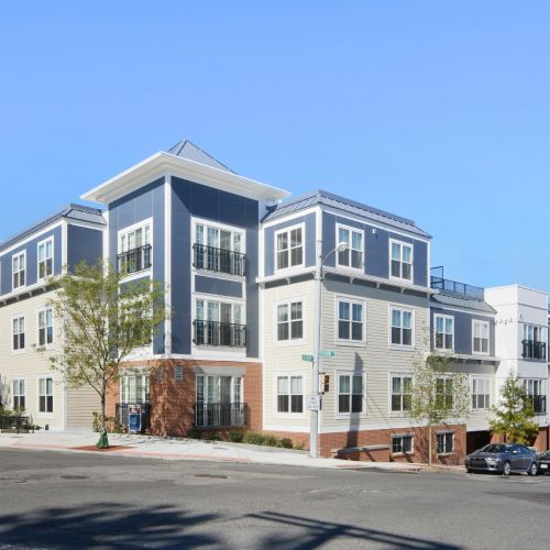 Aerial view of a modern apartment complex with adjacent parking lot