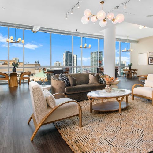 The lounge features floor-to-celing glass, allowing sunlight to fill the open-layout interior.	