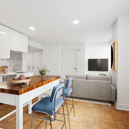 Style and function blend seamlessly in this living room, with moveable kitchen islands offering versatility for any occasion.	