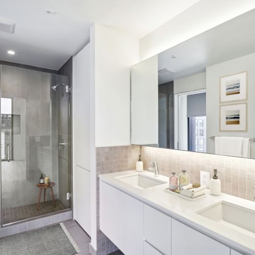 Large bathrooms accompanied by sleek stone finishes