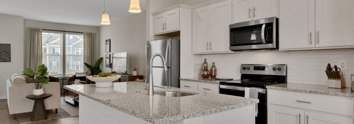 Kitchen with large island looking into living room 