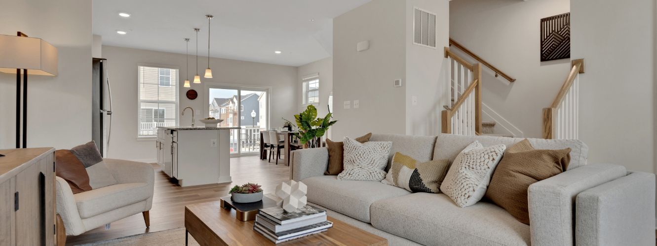 Living room with view of kitchen and stairs 
