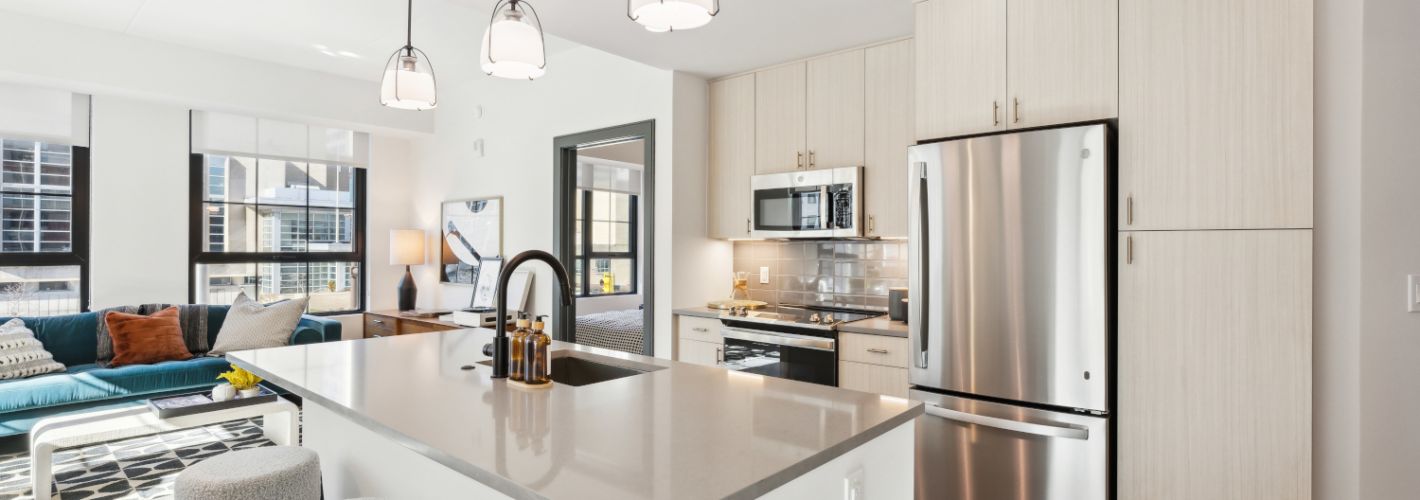 Kitchen island with stools looking towards living room