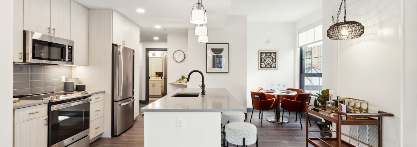 Apartment kitchen with dining table in back corner
