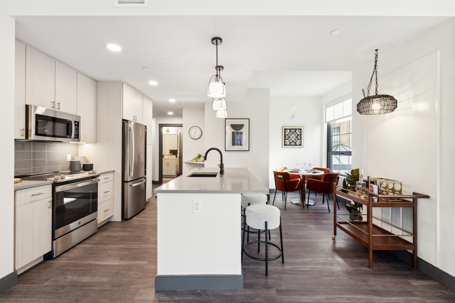 Apartment kitchen with dining table in back corner