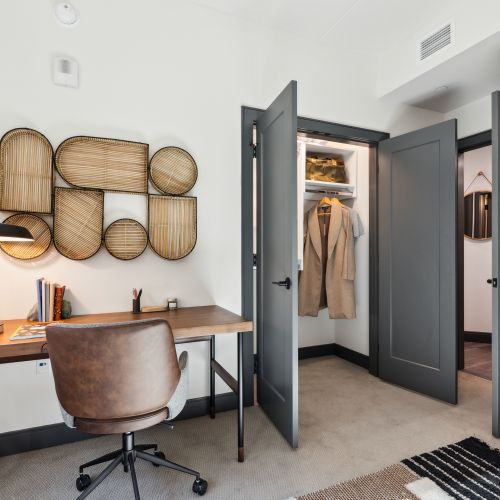 Desk next to a double-door closet