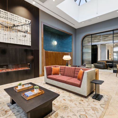 Resident lounge with seating and a fireplace