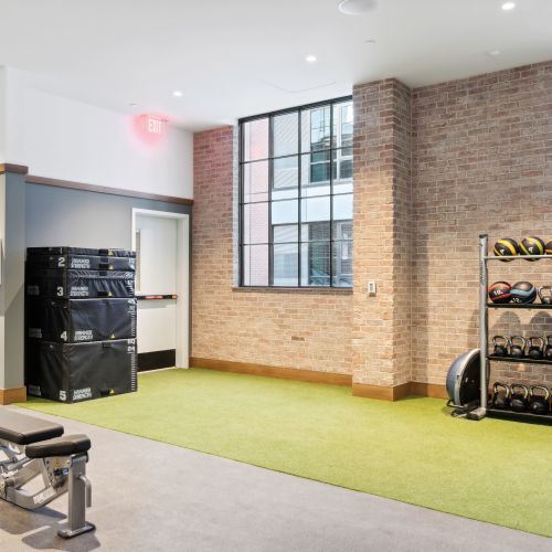 Turf section of fitness center with workout equipment