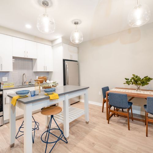 Apartment kitchen with island and dining table 	