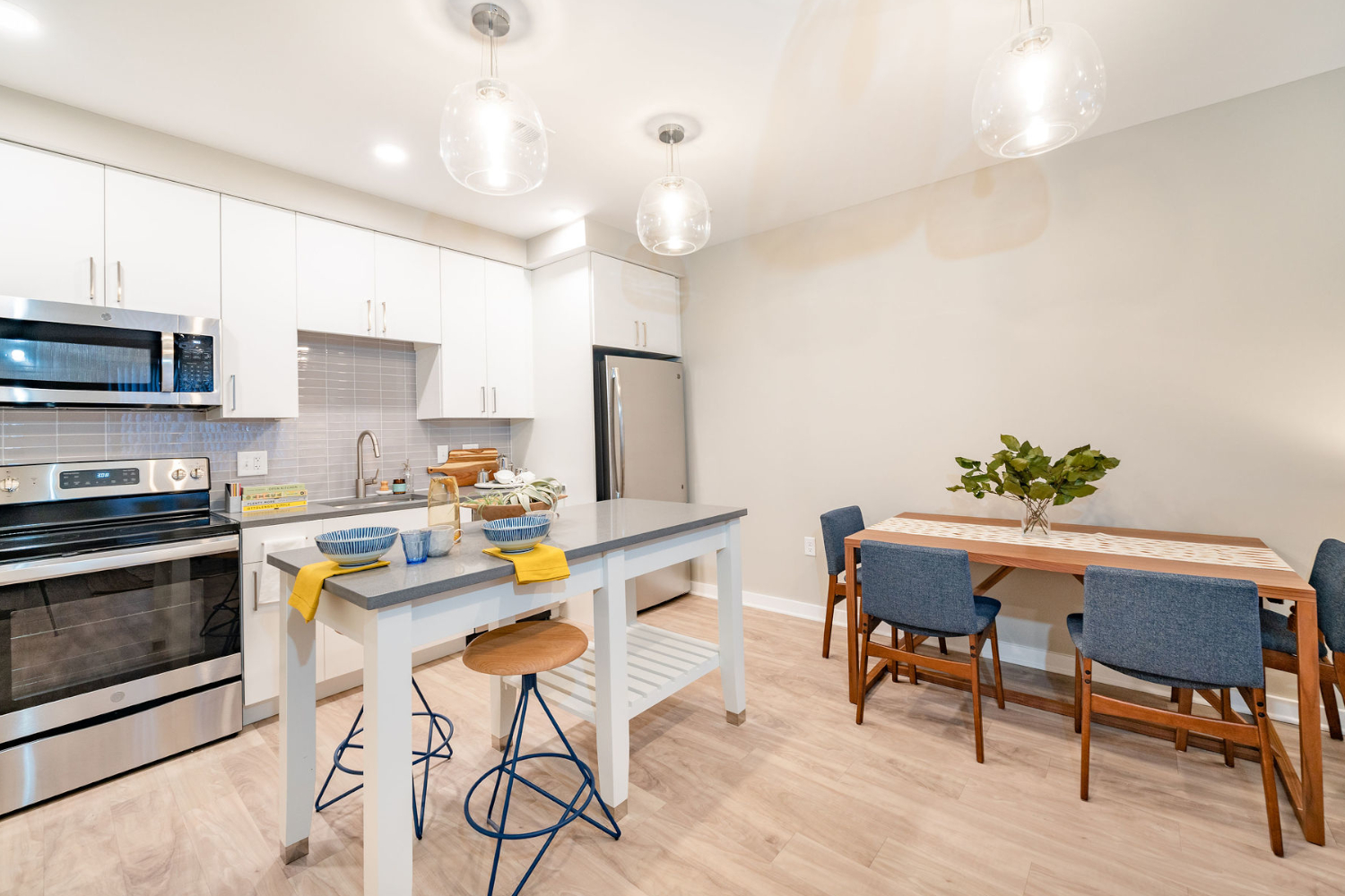 Apartment kitchen with island and dining table 	