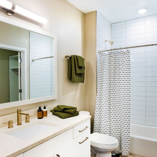 Bathroom with white finishes and bathtub	