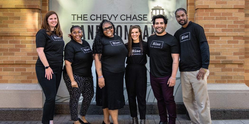 Six individuals wearing 'Rise by Bozzuto' shirts