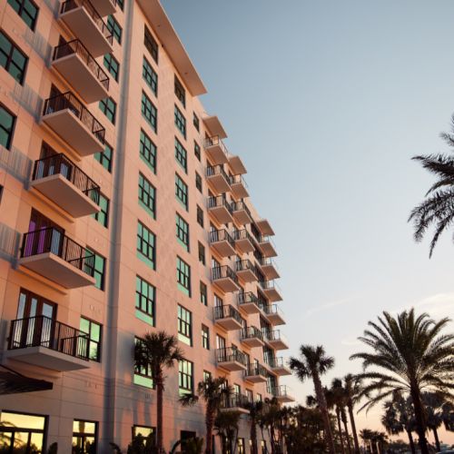 Sunset reflection on exterior building of NOVEL Beach Park