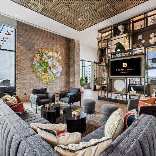 Lounge with mural, couch and TV	