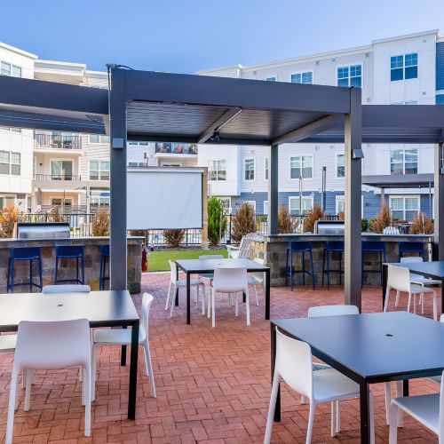 Outdoor dining area with view of screen	